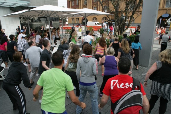 Early morning commuters kick-start their Friday morning with a Les Mills workout on Queen Street